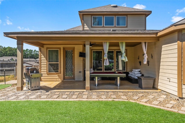 rear view of house with a yard, a patio area, and ceiling fan