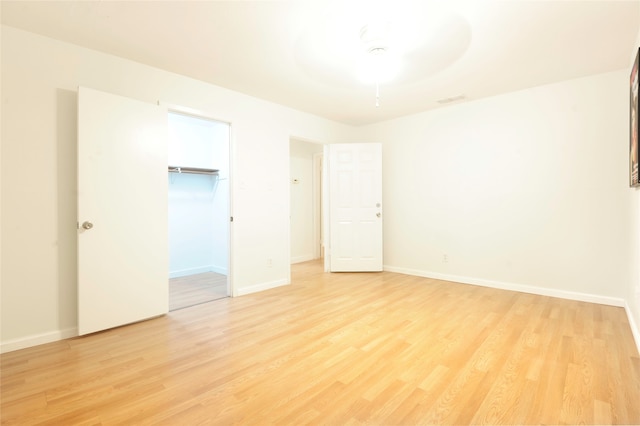 spare room featuring light hardwood / wood-style flooring and ceiling fan