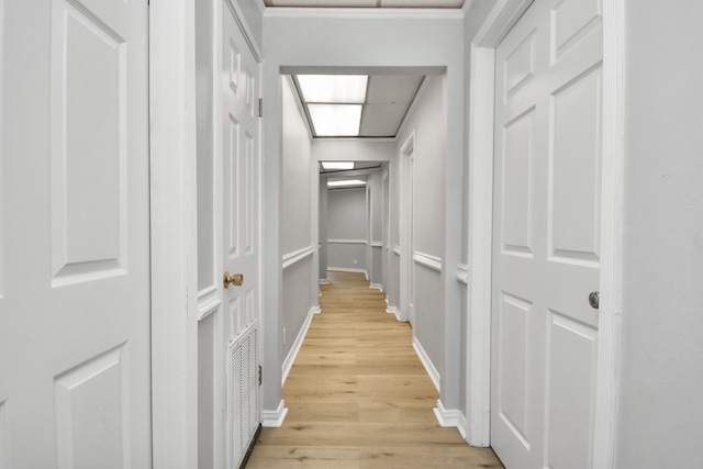 corridor with light hardwood / wood-style flooring