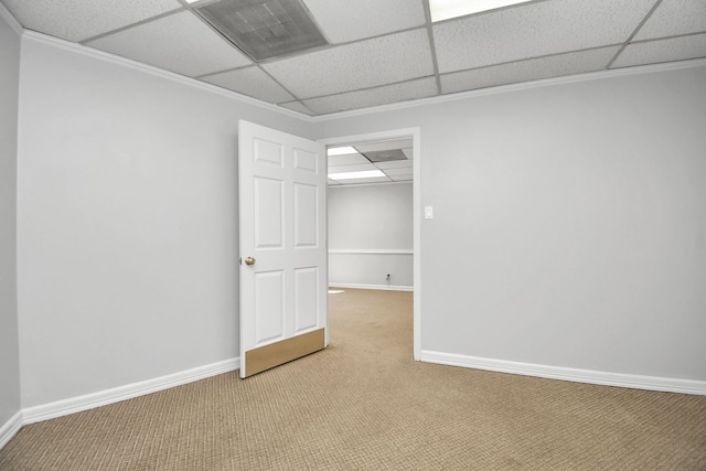 unfurnished room with a paneled ceiling, crown molding, and carpet floors