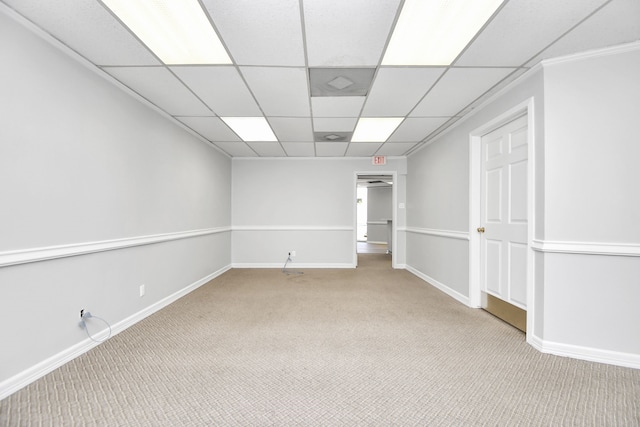 spare room with a drop ceiling and light colored carpet