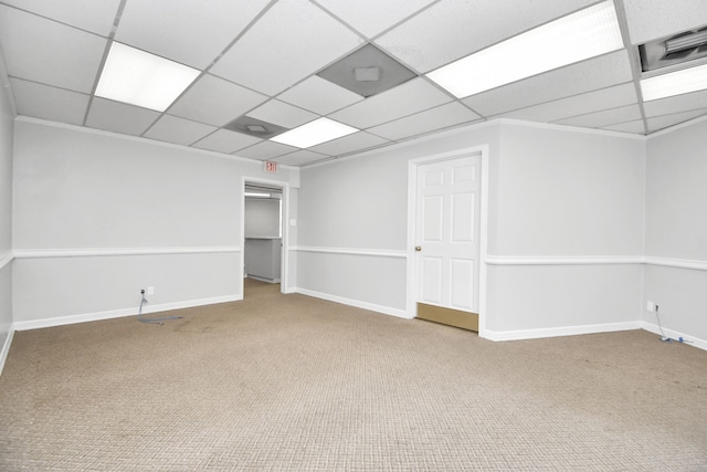 carpeted spare room with a drop ceiling