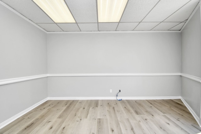 unfurnished room featuring light hardwood / wood-style flooring and a drop ceiling