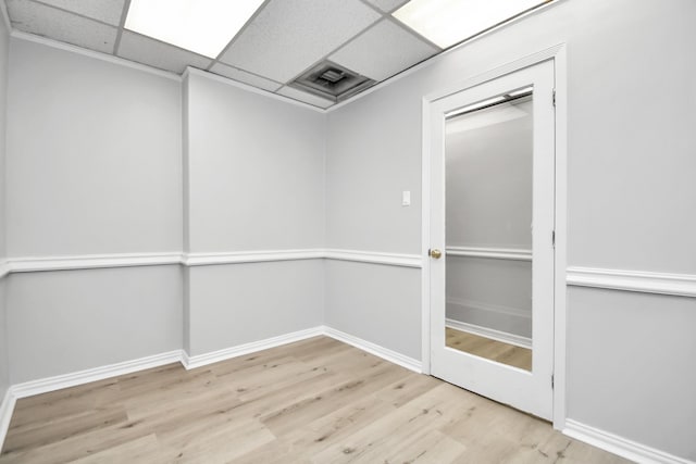 empty room featuring light hardwood / wood-style floors and a drop ceiling