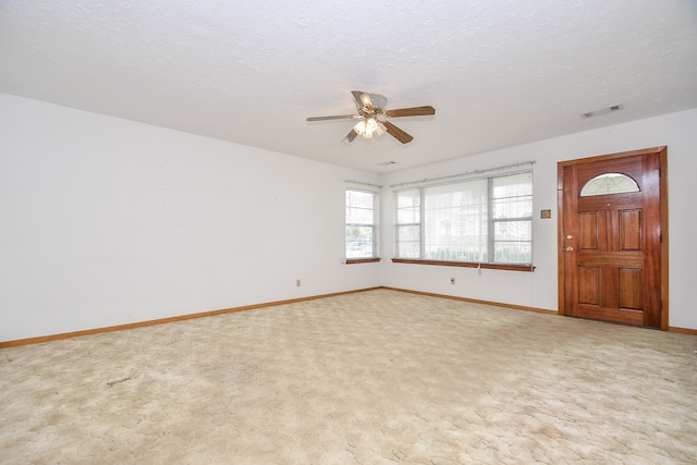 interior space featuring ceiling fan and a textured ceiling