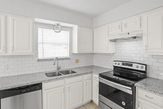 kitchen with decorative backsplash, stainless steel appliances, sink, premium range hood, and white cabinetry