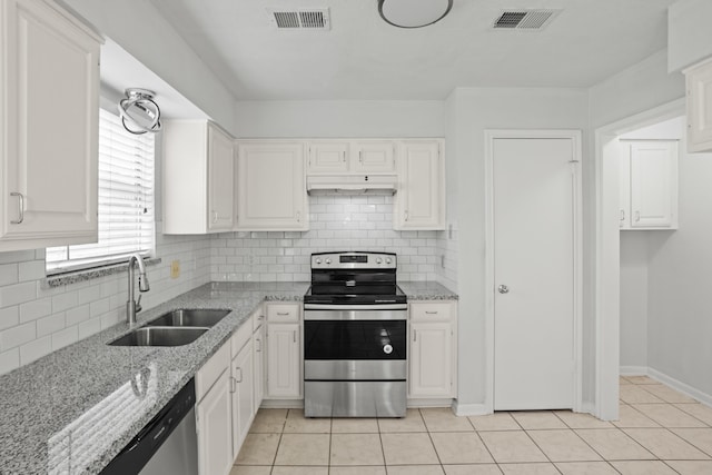 kitchen featuring sink, white cabinets, stainless steel appliances, and light tile patterned flooring