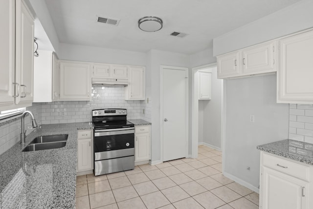 kitchen with electric range, light tile patterned floors, white cabinetry, light stone countertops, and sink