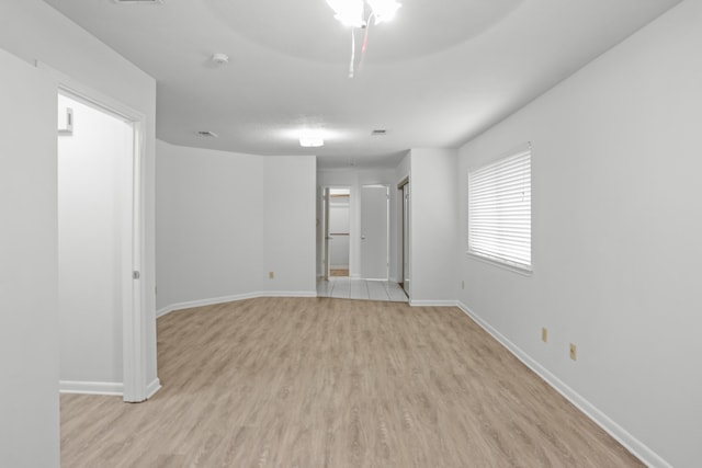 unfurnished room featuring ceiling fan and light wood-type flooring