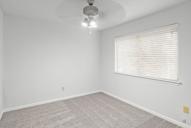 spare room with carpet floors and ceiling fan