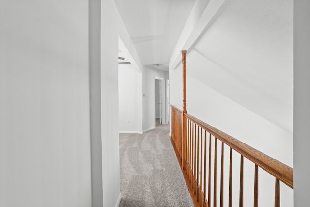 hall featuring vaulted ceiling and light carpet