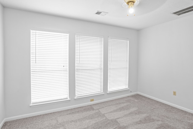 empty room featuring light carpet and ceiling fan