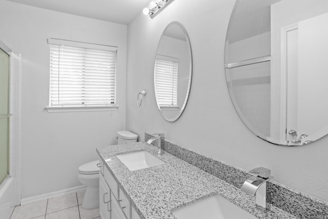 full bathroom featuring vanity, enclosed tub / shower combo, toilet, and tile patterned floors