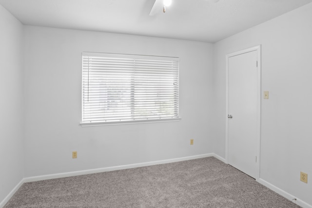 carpeted empty room featuring ceiling fan