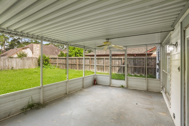 unfurnished sunroom featuring ceiling fan