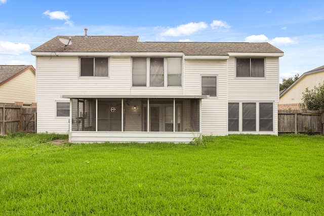 back of property featuring a sunroom and a lawn