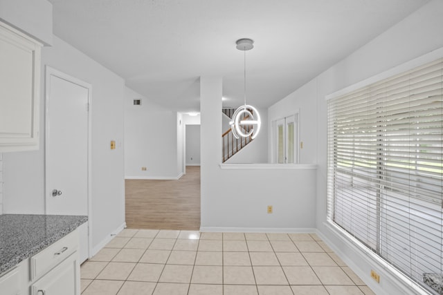 unfurnished dining area with light hardwood / wood-style floors