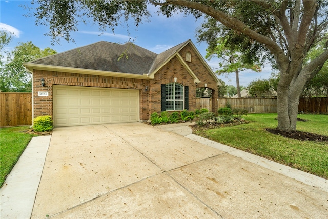 view of front of house featuring a front yard and a garage