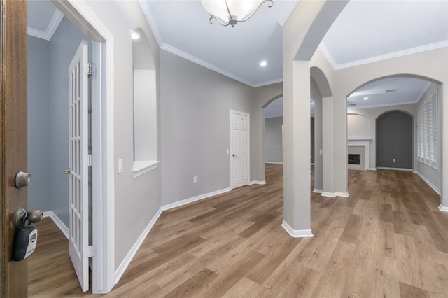 entryway featuring crown molding and light hardwood / wood-style flooring