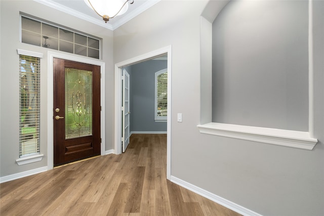 entryway featuring crown molding and light wood-type flooring