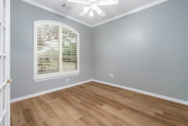 spare room with crown molding and light wood-type flooring