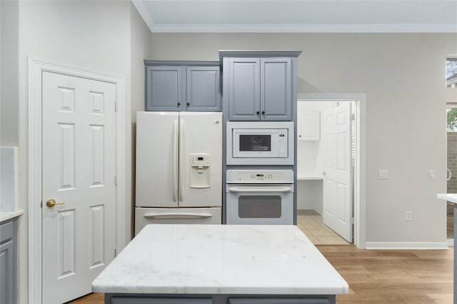 kitchen with white appliances, ornamental molding, light wood-type flooring, and gray cabinetry