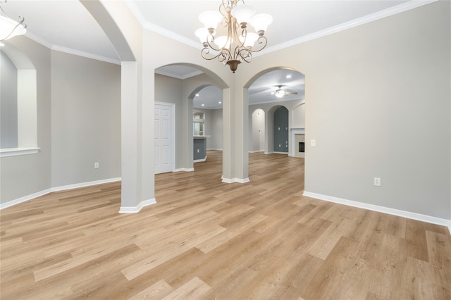 unfurnished dining area with light hardwood / wood-style floors, crown molding, and ceiling fan with notable chandelier