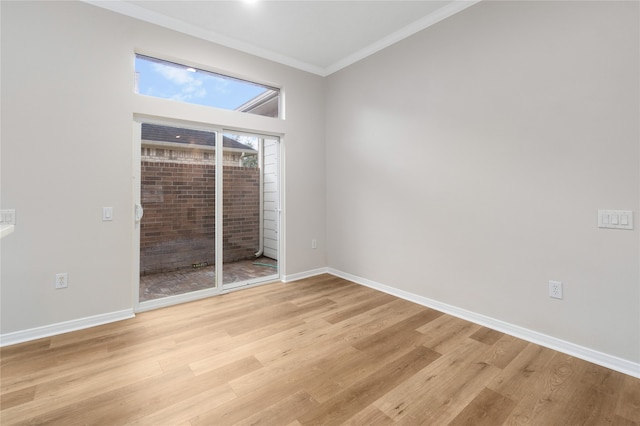 empty room with crown molding and light hardwood / wood-style flooring