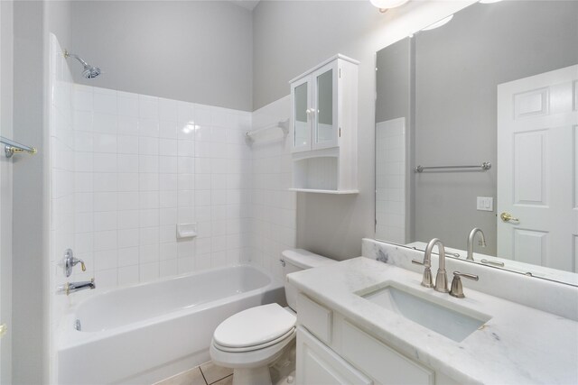 full bathroom featuring vanity, toilet, tile patterned floors, and tiled shower / bath