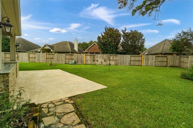 view of yard featuring central AC and a patio area