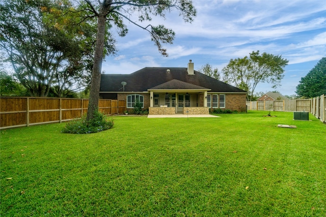 back of house with a lawn