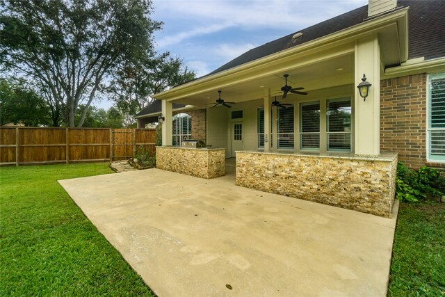 view of patio with area for grilling and ceiling fan