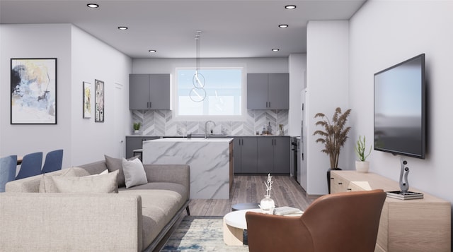 living room featuring sink and hardwood / wood-style floors