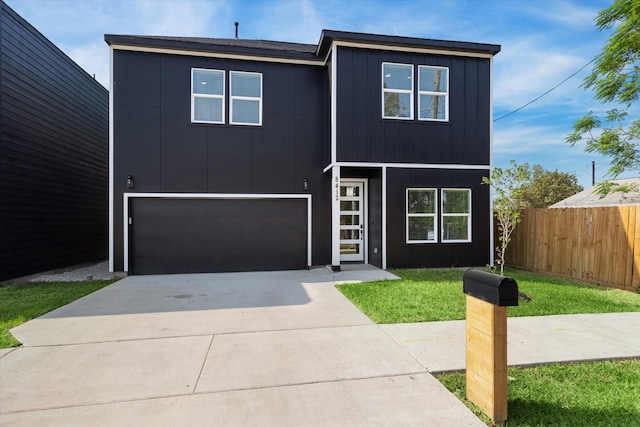 view of front facade with a garage and a front lawn