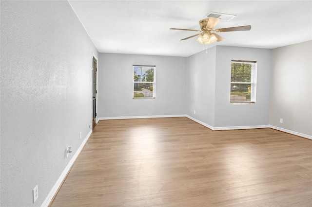 unfurnished room featuring a wealth of natural light and light wood-type flooring