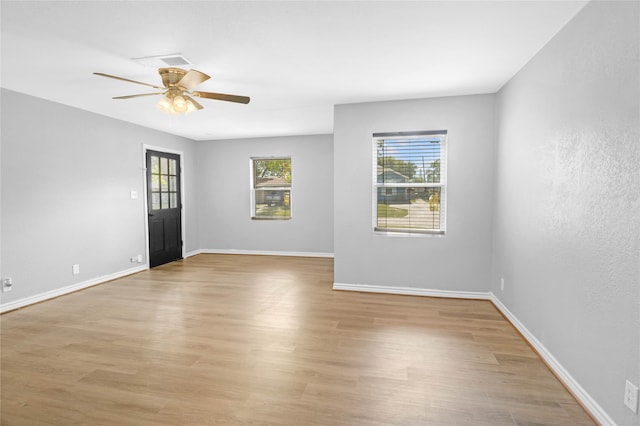 empty room with light hardwood / wood-style floors and ceiling fan