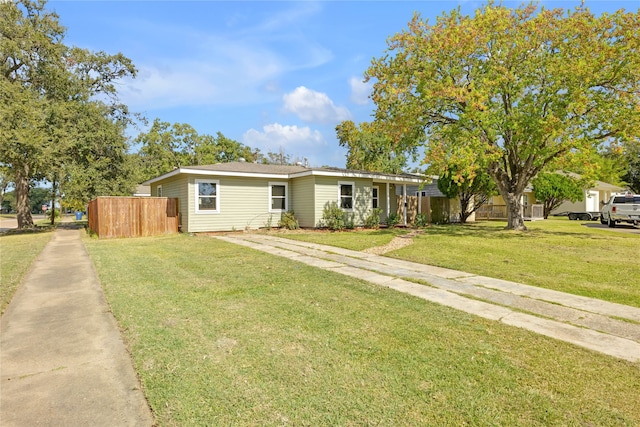 single story home featuring a front lawn