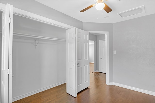 unfurnished bedroom with a closet, hardwood / wood-style flooring, and ceiling fan