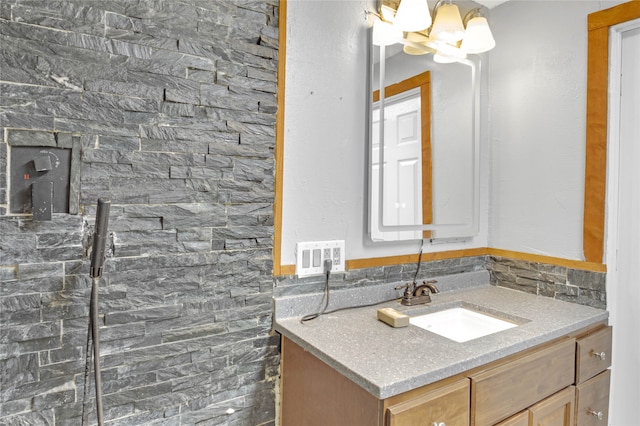 bathroom featuring vanity and a chandelier