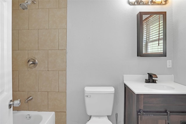 full bathroom featuring vanity, toilet, and tiled shower / bath combo