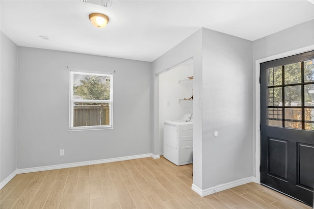 entrance foyer with washer / dryer and light hardwood / wood-style flooring