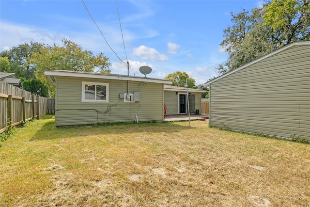 rear view of house with a patio area and a lawn