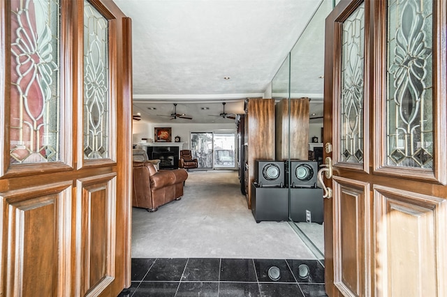 entrance foyer with a textured ceiling and dark tile patterned floors