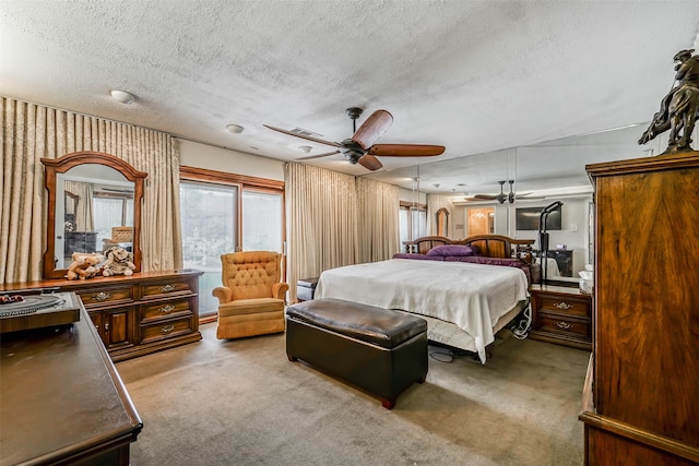 carpeted bedroom with a textured ceiling and ceiling fan