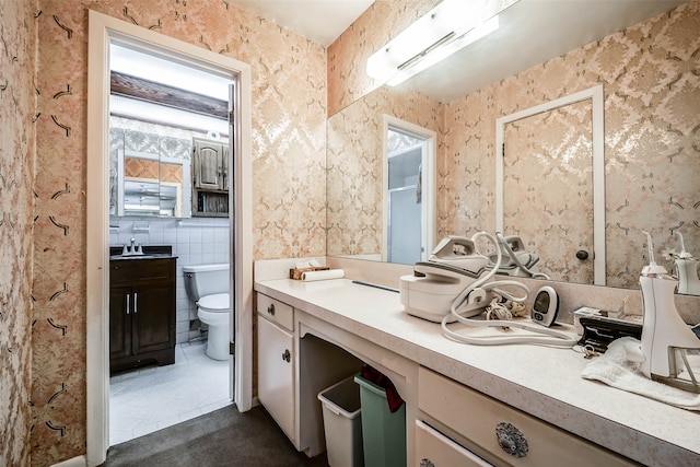 bathroom featuring vanity, toilet, and tile patterned flooring