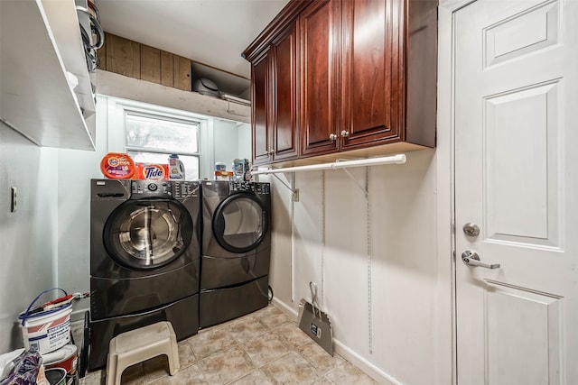 washroom featuring cabinets, washer and dryer, and light tile patterned floors