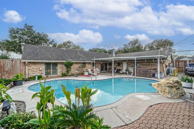 view of pool with a hot tub and a patio area