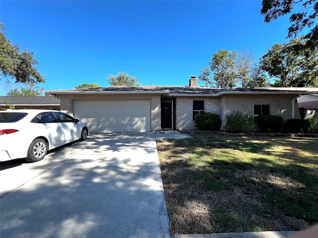 single story home with a garage and a front lawn