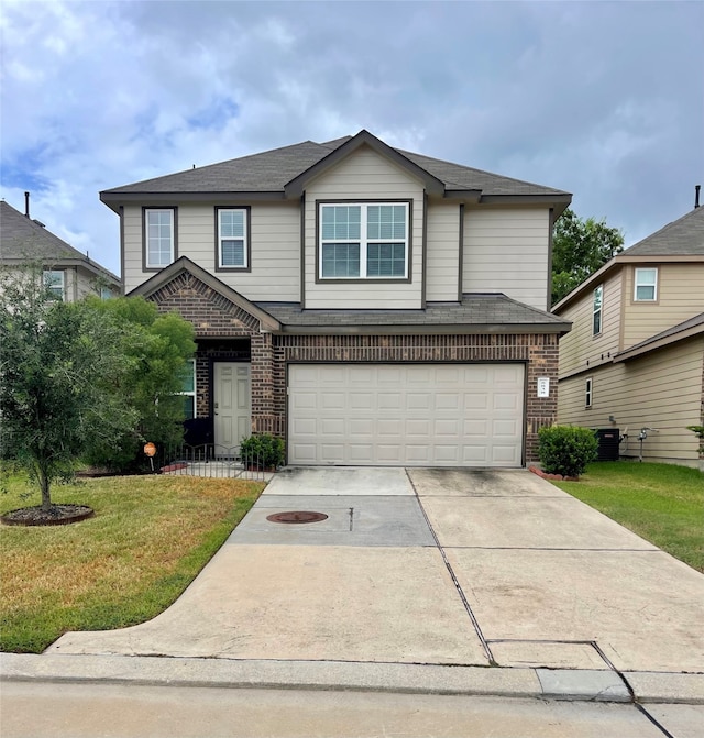 view of property featuring a front yard and a garage