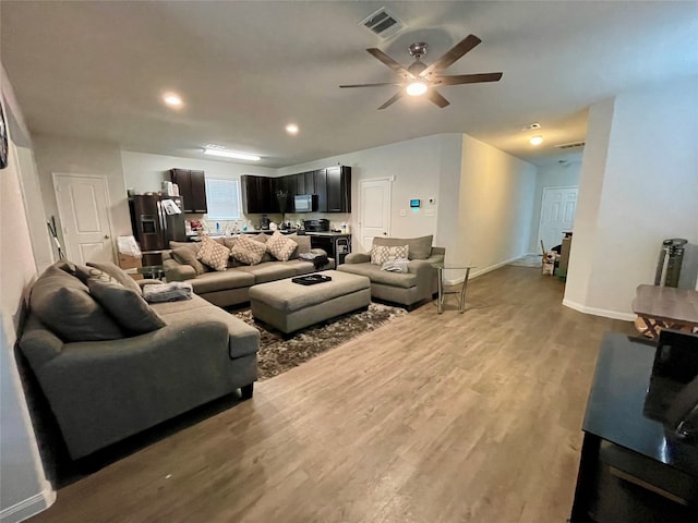 living room featuring hardwood / wood-style flooring and ceiling fan